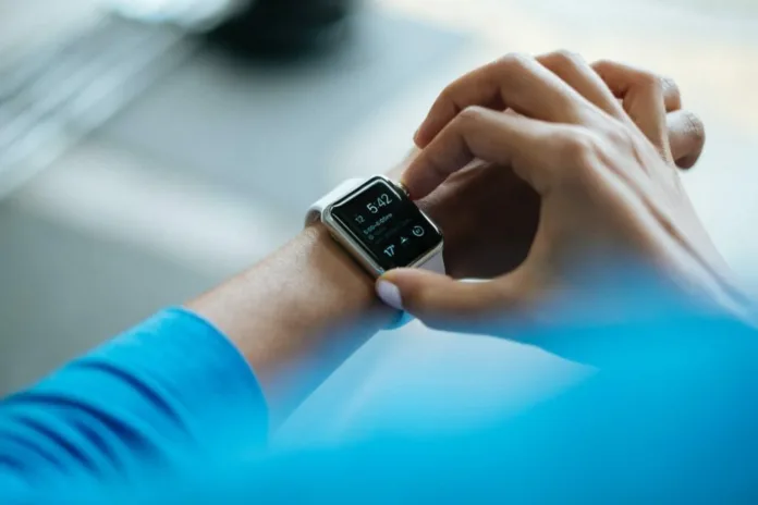 Lifesaving-Wearable-Technology Person interacting with a smartwatch featuring health monitoring and emergency SOS features