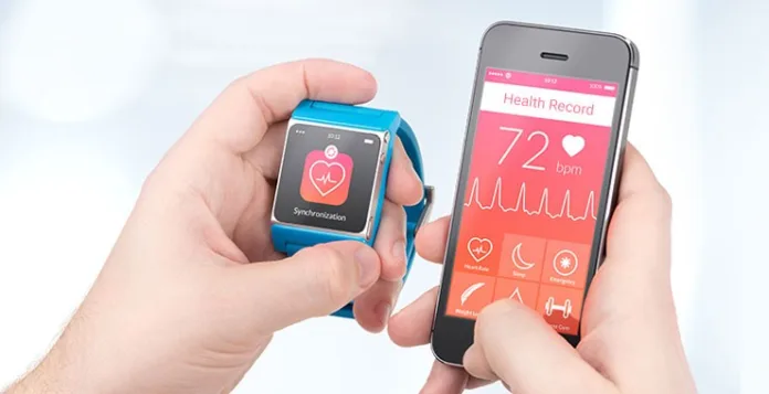 A user synchronizes health data between a smartwatch and a smartphone app, showing a heart rate of 72 bpm. Person holding a smartwatch and smartphone displaying synchronized heart rate data.