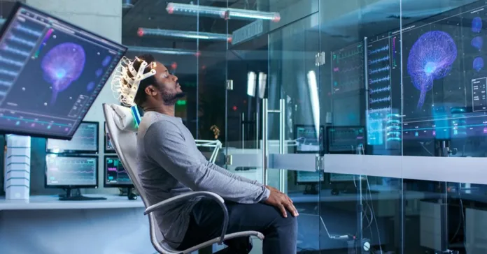 1111-e1573834183704 Man using neural interface headset to interact with brain-computer system in a modern research lab