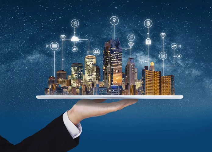 The-Future-of-Smart-Cities-Transforming-Urban-Living-with-Technology_18_11zon Hand presenting a digital smart city model with interconnected IoT icons representing urban technology innovation.