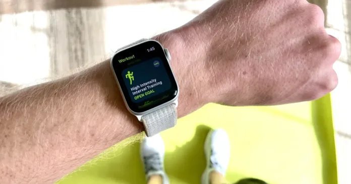 smartwatch-health-data-accuracy Person wearing a smartwatch displaying High Intensity Interval Training workout screen